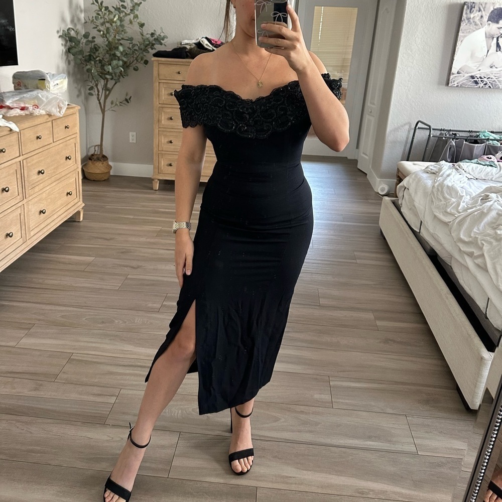 Off the shoulder black evening dress with slit and rhinestones